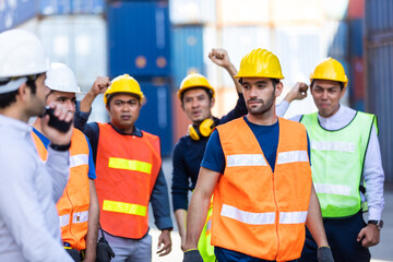 Strike of workers in container yard. Group of multiethnic engineer people during a protest in workplace