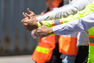 Success Team of foreman and worker people showing thumbs up sign in workplace. container yard port of import and export. Business teamwork concept