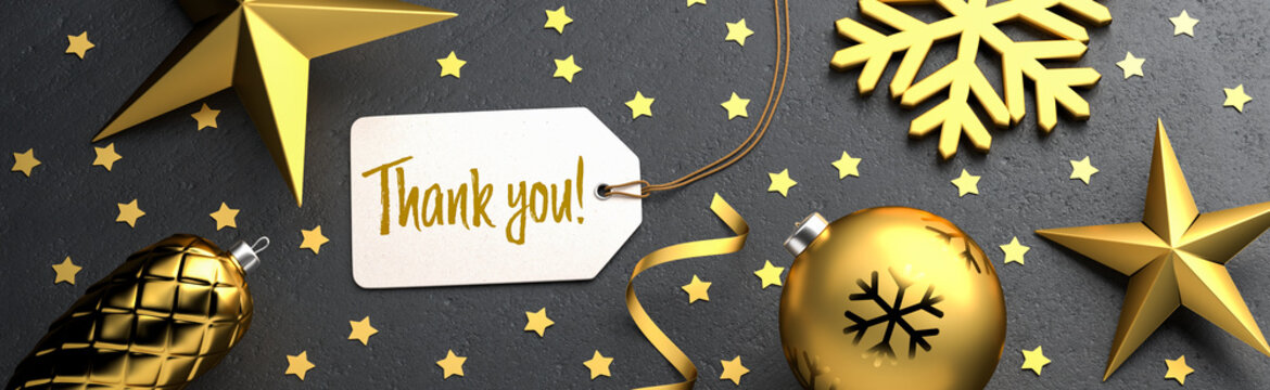 Christmas - Gift Tag with the message "Thank you" on a black stone background with gold colored christmas ornaments around. Banner size.