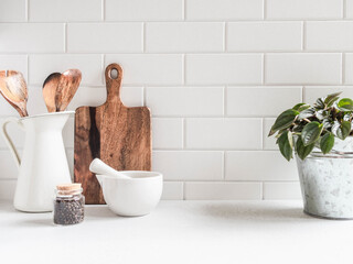 Kitchen background with kitchen utensils and houseplant