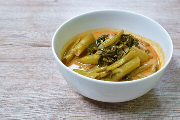 spicy boiled morning glory with fat pork in coconut milk curry or Kaeng The Po Thai food on bowl