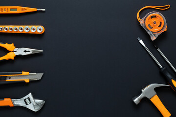 Labor Day  gift card with copy space for text, set of tools on black background. Frame, mockup with empty place. Construction, repair, DIY concept. Engineering workplace. Renovation project design.