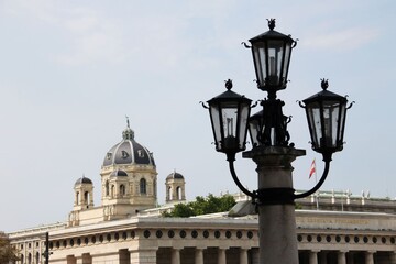 street lamp next to a dome in streets of Vienna