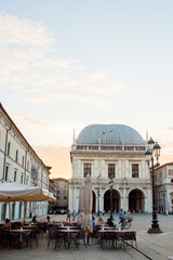 Panoramic view of Loggia palace ( palazzo della loggia) of Brescia square during sunset at the end of the summer.