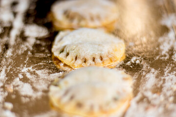 Close up. Home made filled pasta with vegetables. Flour on the floor and reflection