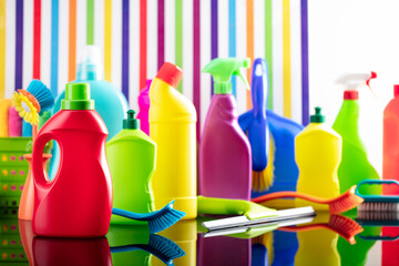 House and office cleaning theme. Colorful set of bottles with clining liquids on background in the form of colorful stripes.