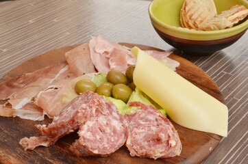 Assorted ham, hamon, salami, olive and cheese platter for snack at venice, Italy.