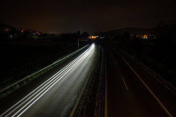 White car lights on a road in night