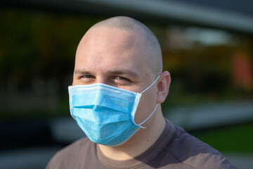 Young man with smiling eyes wearing a face mask