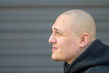 Profile of a casual young man with shaved head