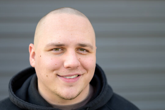 Modern smiling young man with shaved head