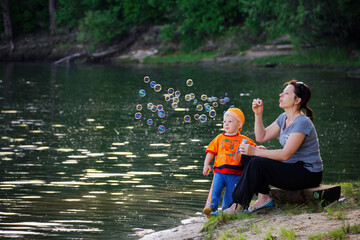 mother with little son by the water on the lake