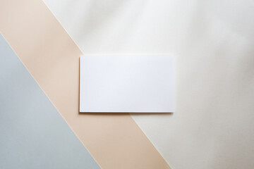 Blank white business card mockup on colorblock table backgound. branding, template for text, soft shadow.