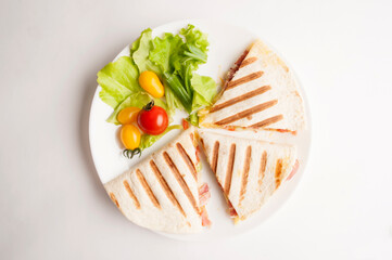 Grilled tortilla on white background top view