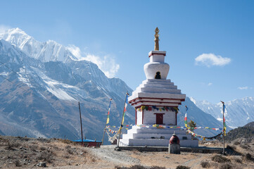 Buddhist stupa temple with Annapurna massive in distance. Annapurna Circuit Trail, Manang, Nepal