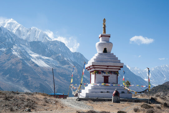 Buddhist stupa temple with Annapurna massive in distance. Annapurna Circuit Trail, Manang, Nepal