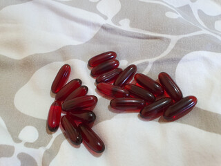 Red oval pills on the bed food suplament Curcumin