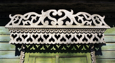 Fragment of the Window of an old Russian wooden house from the times of the Russian Empire with...