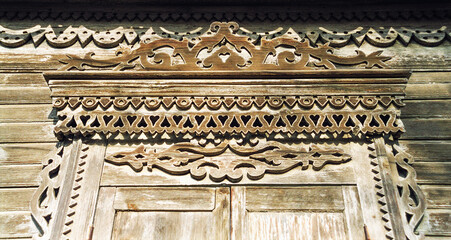 Fragment of the Window of an old Russian wooden house from the times of the Russian Empire with elements of carved decorations.
Astrakhan, Russia.