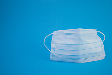Protect blue face mask from covid-19 on blue background
