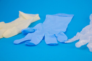 Multicolor latex gloves on blue background