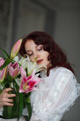 beautiful girl with a bouquet of lilies