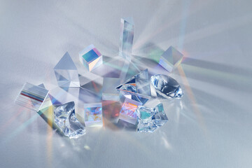 Crystal refracting light in rainbow colors on cold background.