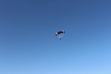 Person falling from the sky by parachute