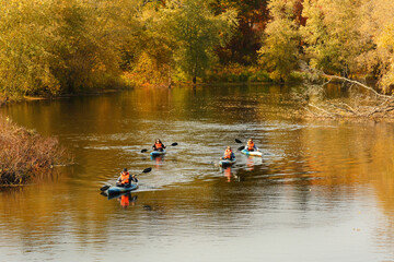 Fototapeta na wymiar Tourists kayaking on the Concord River at Minute Man National Historic Park with fall foliage as background, Concord Massachusetts. 