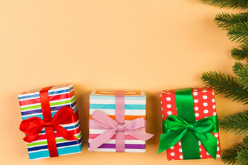 Fototapeta premium Top view of colorful holiday background made of fir tree and gift box. Happy New Year concept with copy space