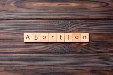 Abortion word written on wood block. Abortion text on cement table for your desing, concept