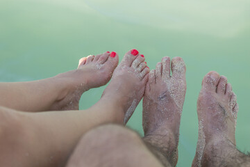 photograph of a couple's feet on the beach
