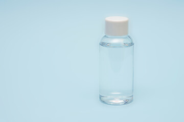 Bottle with disinfectant for hands from the virus Covid-19 on a blue background