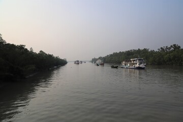 Fototapeta premium Launches on the river at the largest mangrove forest- Sundarbans in Bangladesh