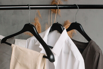 black hanger with white shirt and pants