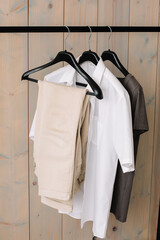 black hanger with white shirt and pants