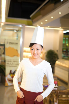The happy bakery saleswoman is in the bakery 