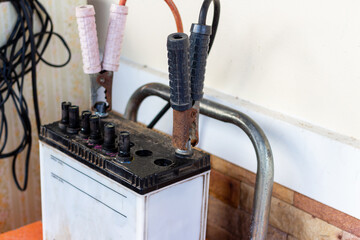 Car maintenance.Charging the car battery in the garage