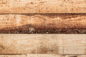 Horizontally laid unplaned pine board for rough work. Natural wooden rough background.