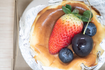 Basque burnt cheesecake homemade decorate by strawberry and blueberry