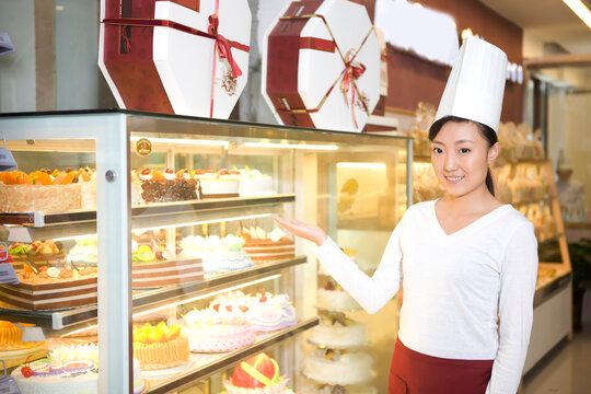 The happy bakery saleswoman is in the bakery