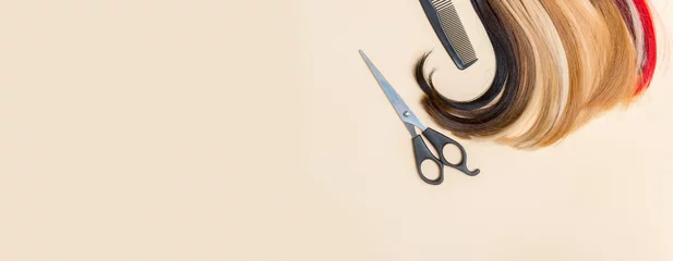 Store enrouleur Salon de beauté Hairdresser's scissors with comb and strand of hair on camel color background. Hairdresser service
