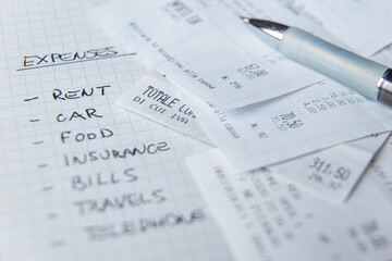 List of daily living expenses, with tax receipts next to it.