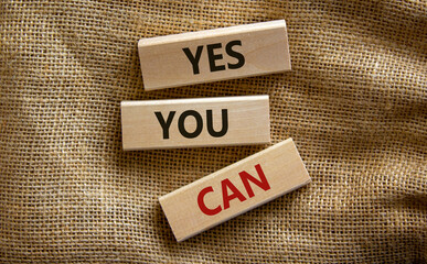 Wooden blocks with words 'yes you can'. Beautiful canvas background. Copy space. Business concept.