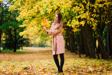 Beautiful woman spending time in park during autumn season