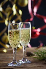 Christmas background, champagne glasses on a wooden surface