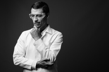 Portrait of handsome man doctor as scientist with protective glasses