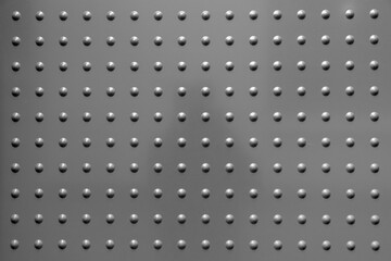 grey metal background with spots in regular pattern
