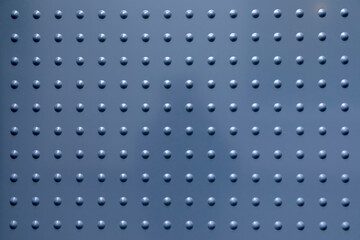 grey metal background with spots in regular pattern