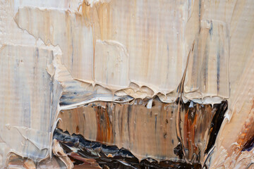 Embossed pasty oil paints and reliefs. Primary colors: ocher, white, brown.  Abstract art.